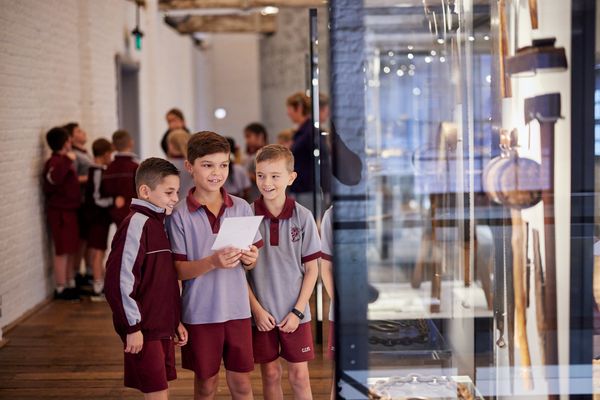 Students examining convict tools to learn about Convict Life at the Barracks on Level 3 of the museum