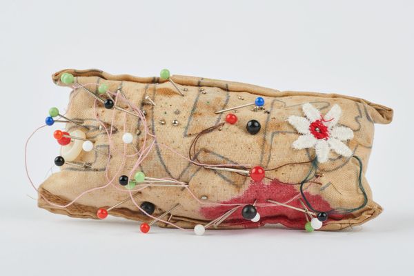 Homemade pincushion with clear plastic bracelet at back made by former Susannah Place resident Ellen Marshall and stuffed with hair from Dennis Marshall, 20th century, cotton and plastic