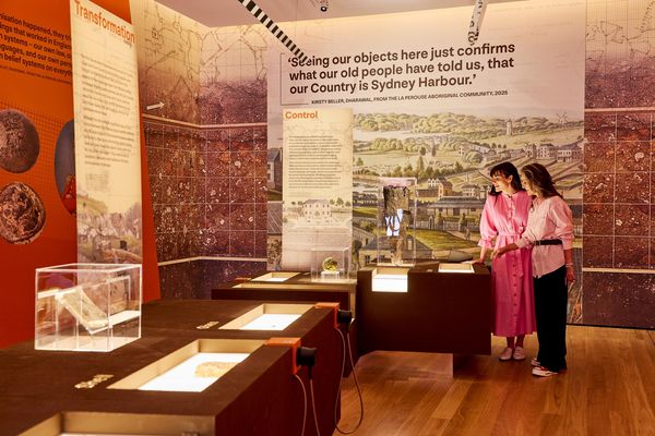 Visitors looking at a display at Unearthed exhibition.