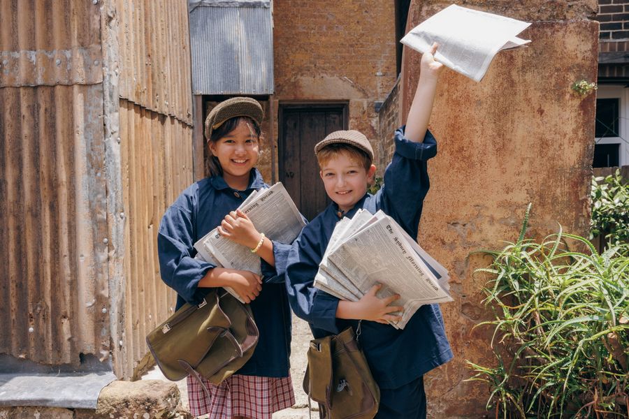 Students in newspaper boy uniforms at Susannah Place.