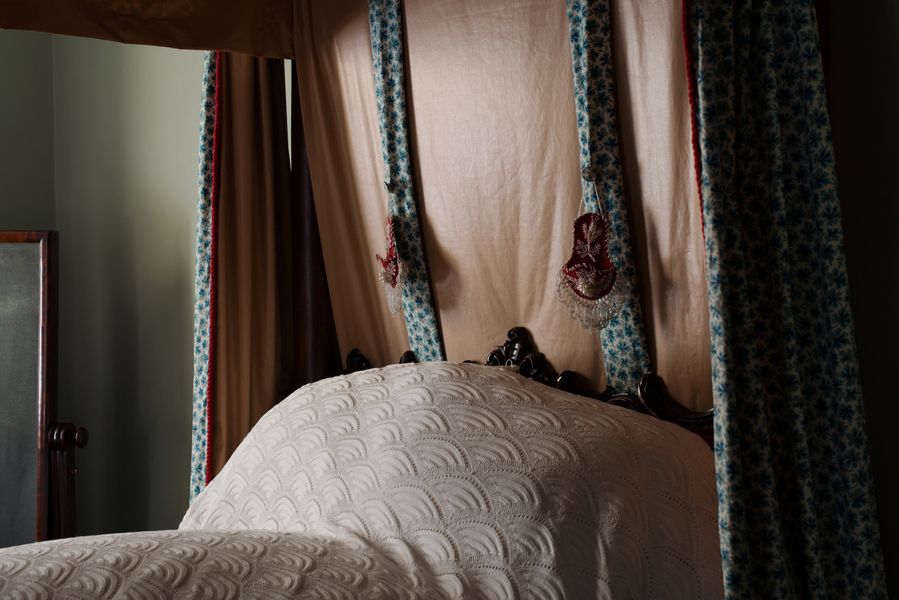 Detail of the four poster bed and beaded watch pockets in the Principal bedroom, Vaucluse House