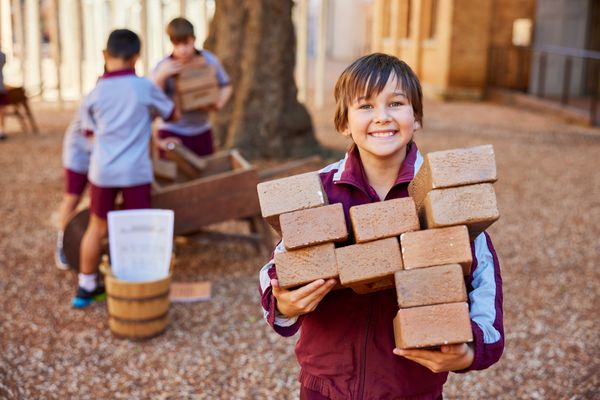 Student carrying convict bricks in the courtyard at Hyde Park Barracks